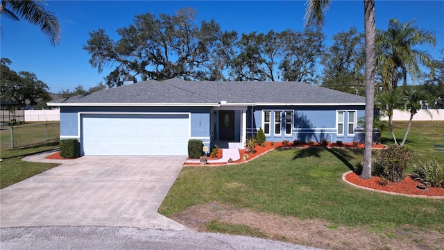 ranch-style home featuring a garage and a front lawn