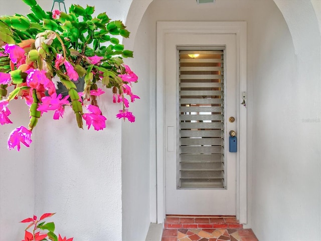 property entrance with stucco siding