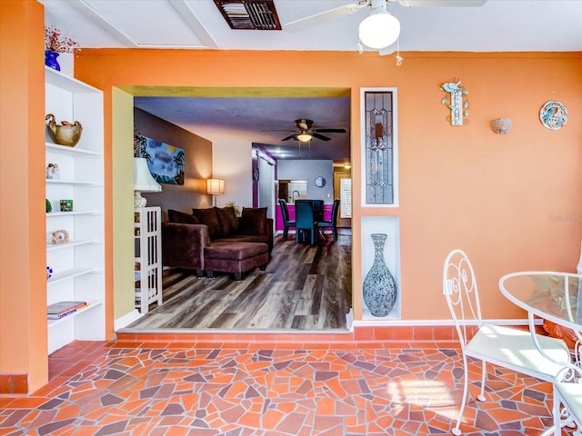 interior space featuring stone finish floor, visible vents, and built in features