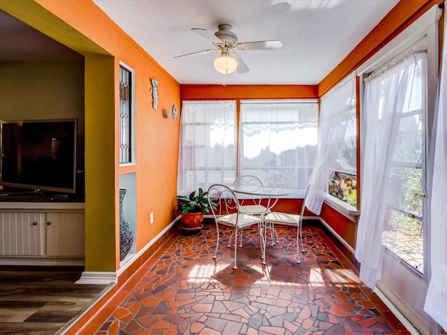 sunroom with a ceiling fan