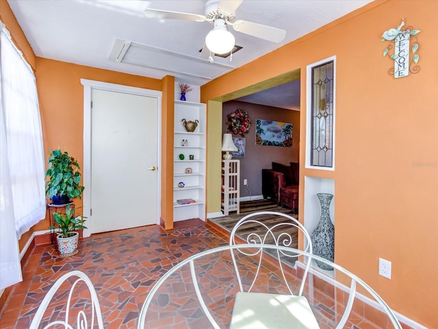 foyer entrance featuring plenty of natural light, baseboards, and ceiling fan