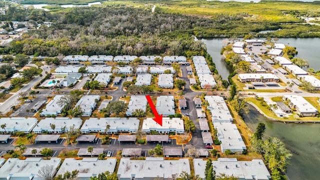 birds eye view of property featuring a water view and a residential view