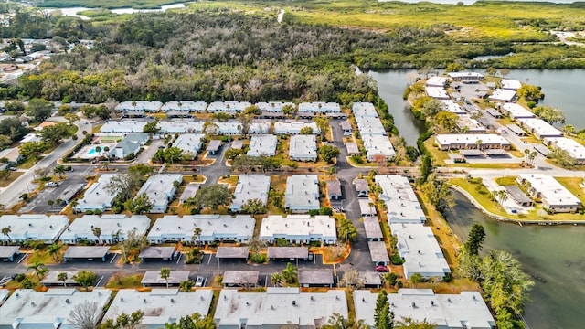 drone / aerial view with a water view and a residential view