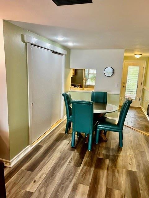 dining space featuring a wealth of natural light and wood finished floors