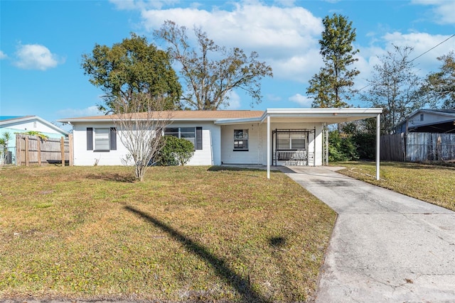 ranch-style house with a carport and a front yard