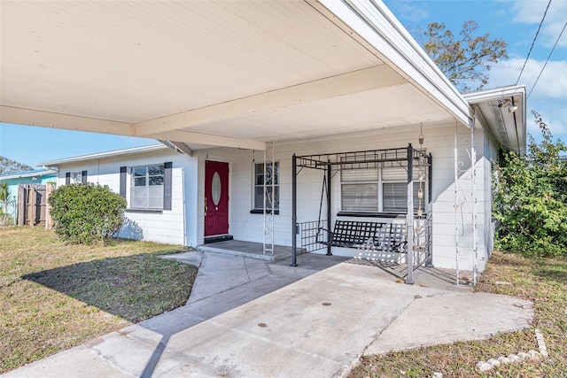 property entrance with a lawn