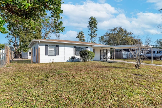 ranch-style house with a front lawn and a carport