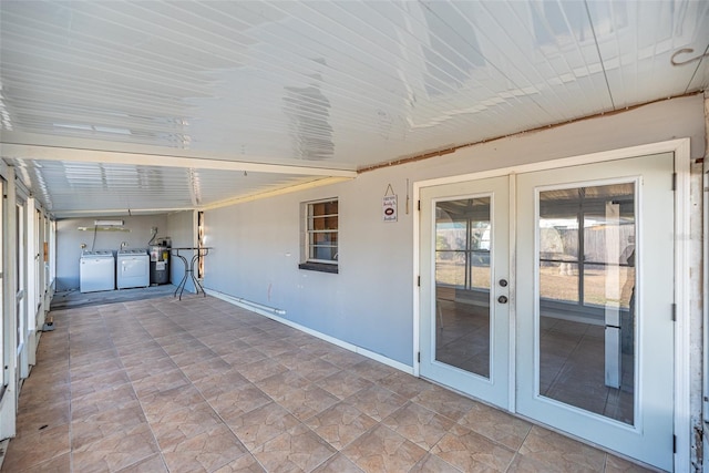 unfurnished sunroom with independent washer and dryer and french doors