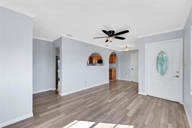 foyer entrance featuring crown molding, ceiling fan, and light hardwood / wood-style floors