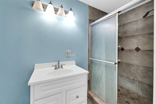 bathroom featuring vanity and a shower with shower door