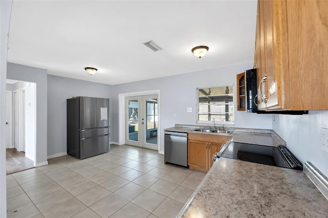 kitchen with sink, plenty of natural light, french doors, and appliances with stainless steel finishes