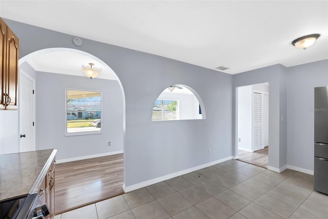 unfurnished dining area with light tile patterned flooring