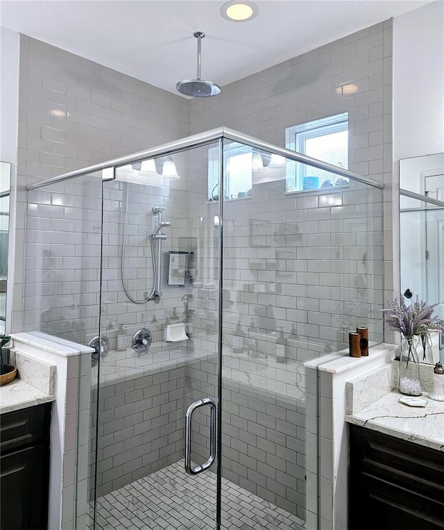 bathroom with vanity and a shower with shower door