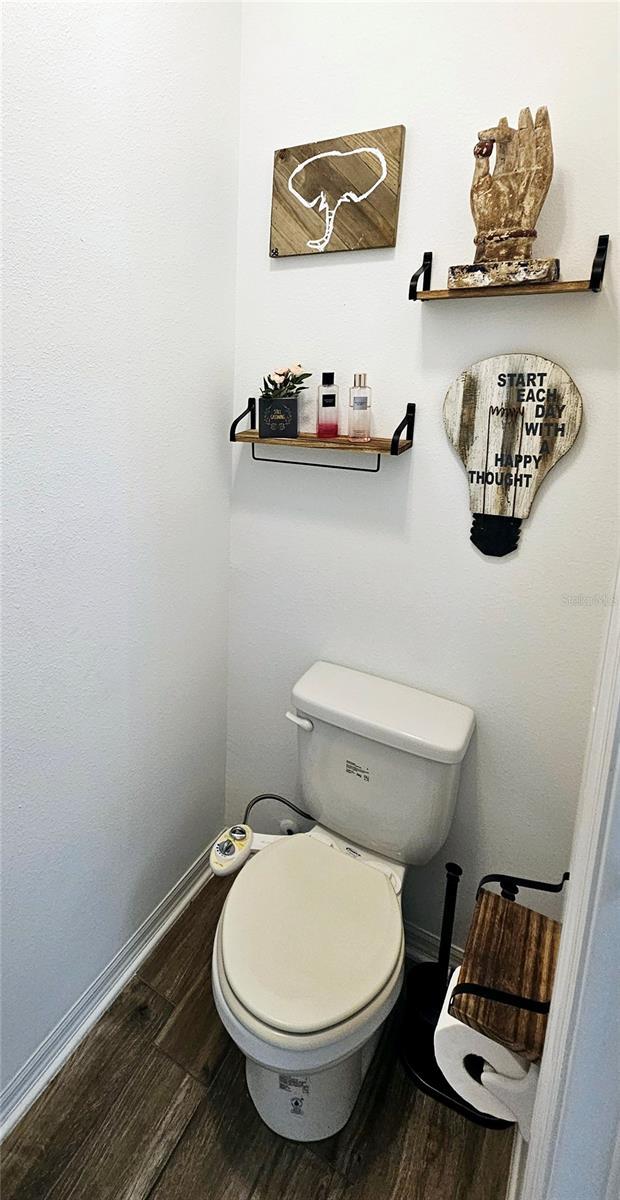 bathroom featuring hardwood / wood-style flooring and toilet