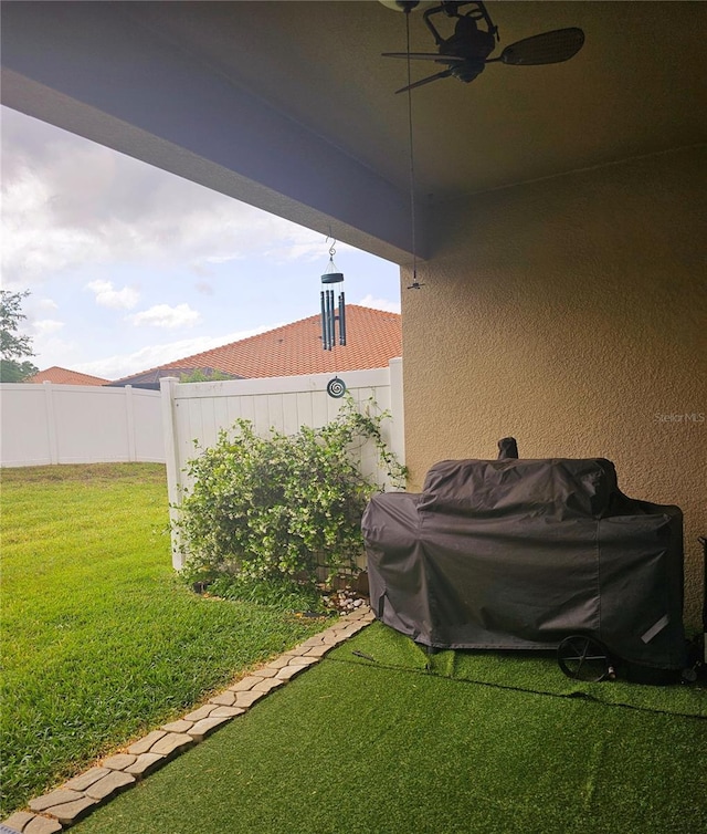 view of yard with ceiling fan