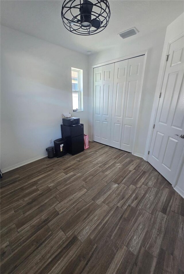 4035 Solamor St, Lakeland, FL 33810 - unfurnished bedroom featuring dark wood-style flooring, baseboards, a closet, and visible vents