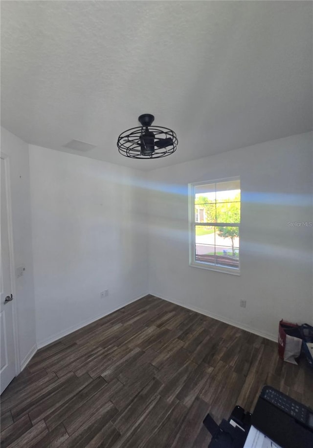 4035 Solamor St, Lakeland, FL 33810 - spare room with dark wood-style flooring, a textured ceiling, and ceiling fan
