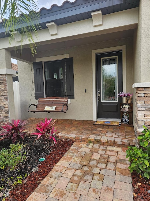 4035 Solamor St, Lakeland, FL 33810 - entrance to property featuring stucco siding and covered porch