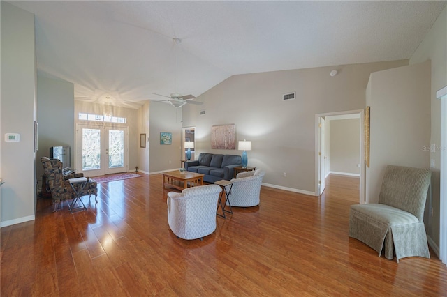 living room with baseboards, visible vents, wood finished floors, and french doors