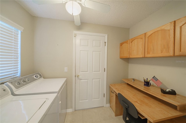 laundry room with a textured ceiling, washing machine and dryer, a ceiling fan, baseboards, and cabinet space