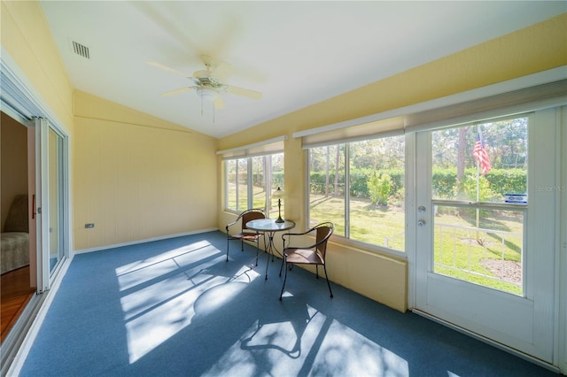 sunroom with a ceiling fan, lofted ceiling, and visible vents