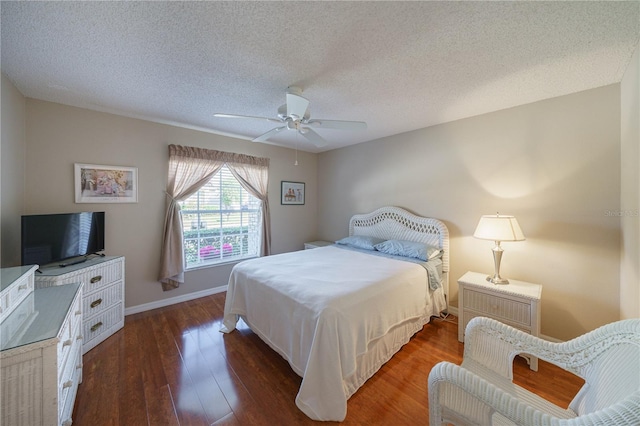 bedroom featuring ceiling fan, a textured ceiling, wood finished floors, and baseboards