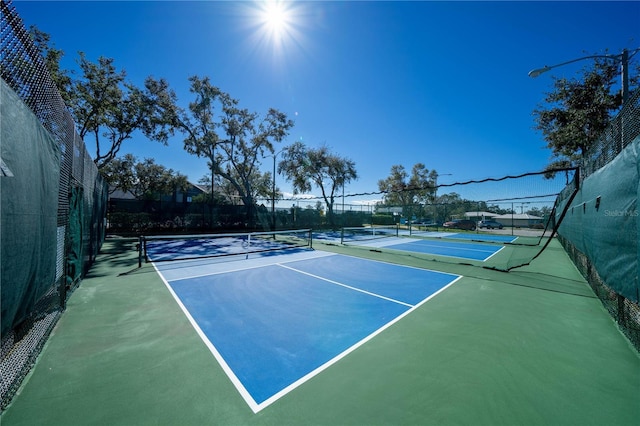 view of sport court with fence