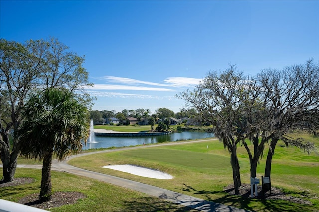 surrounding community featuring a water view, golf course view, and a yard