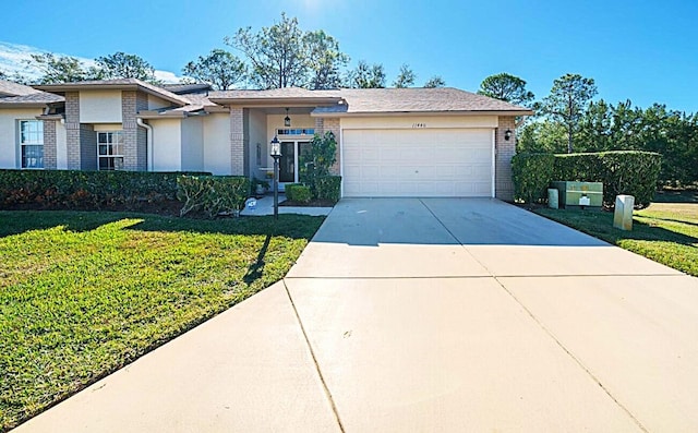 view of front facade with a garage, driveway, brick siding, and a front yard