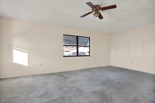 unfurnished room with ceiling fan, carpet floors, and a textured ceiling