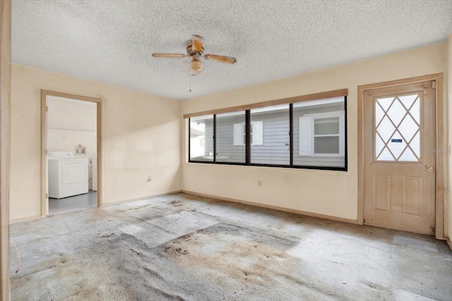 carpeted entrance foyer with ceiling fan, washing machine and dryer, and a textured ceiling