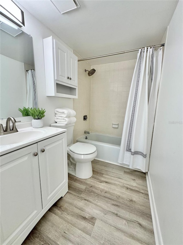 full bathroom featuring shower / bath combo with shower curtain, vanity, toilet, and wood finished floors