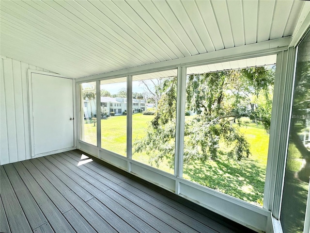 unfurnished sunroom featuring vaulted ceiling