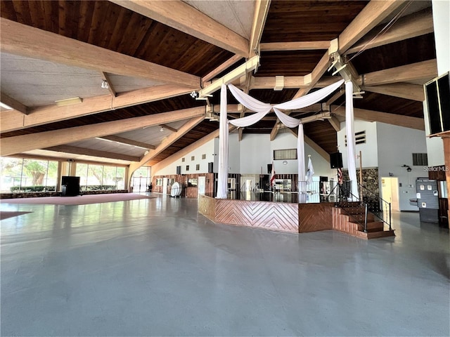 interior space featuring vaulted ceiling with beams, wood ceiling, and finished concrete flooring