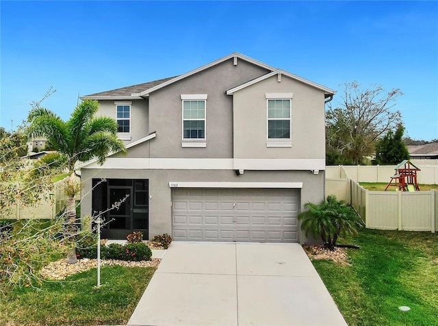 traditional home featuring driveway, an attached garage, fence, and stucco siding