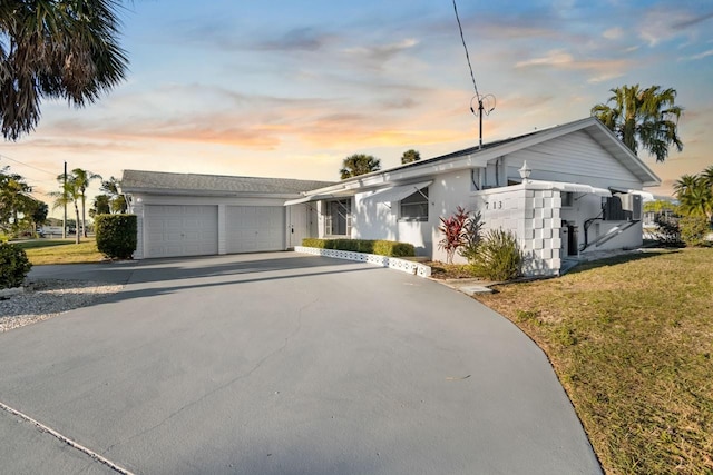 view of front of property with a yard and a garage