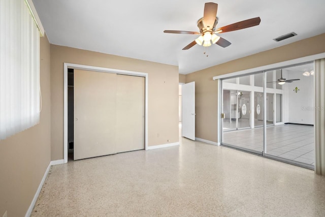 interior space with ceiling fan