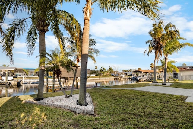 view of home's community with a yard and a water view