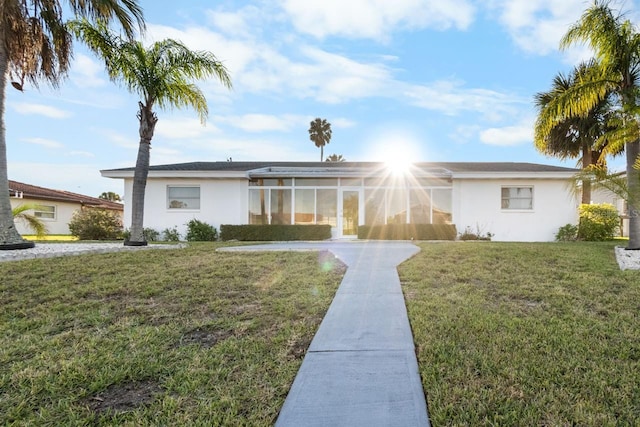 ranch-style house with a front lawn