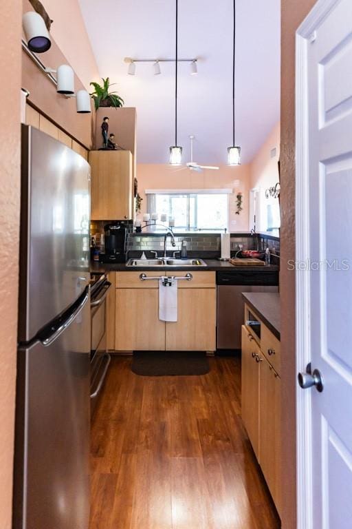 kitchen with sink, light brown cabinets, dark hardwood / wood-style floors, pendant lighting, and stainless steel appliances