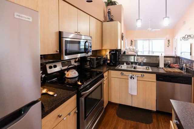 kitchen with sink, decorative light fixtures, light brown cabinets, dark hardwood / wood-style flooring, and stainless steel appliances