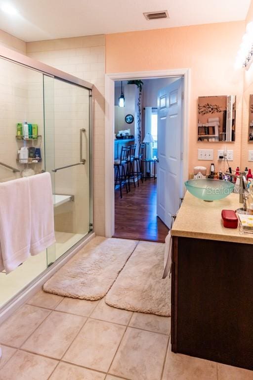 bathroom with vanity, tile patterned flooring, and a shower with door