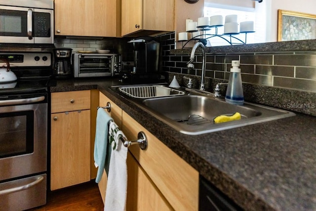 kitchen featuring dark hardwood / wood-style flooring, sink, backsplash, and appliances with stainless steel finishes