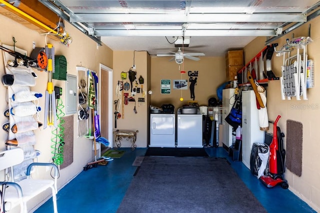 garage featuring electric panel and independent washer and dryer