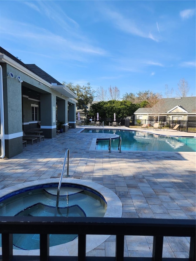 view of swimming pool with a community hot tub and a patio area