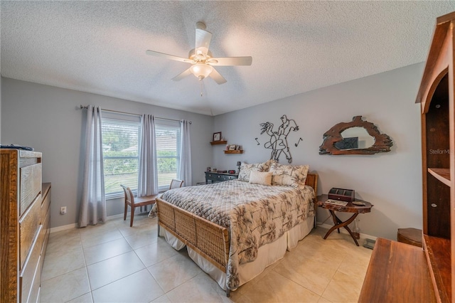 bedroom with light tile patterned floors, a textured ceiling, and ceiling fan