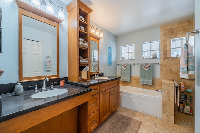 bathroom with tile patterned flooring, vanity, and a bathtub