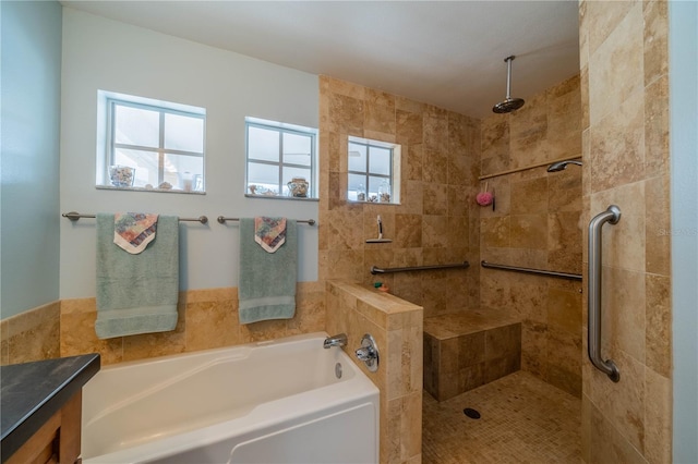 bathroom with vanity and shower with separate bathtub