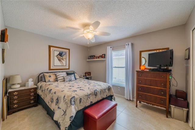 tiled bedroom with ceiling fan and a textured ceiling