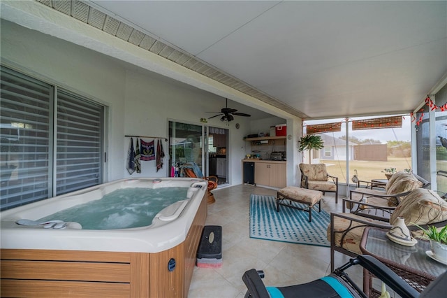 sunroom with ceiling fan and a jacuzzi